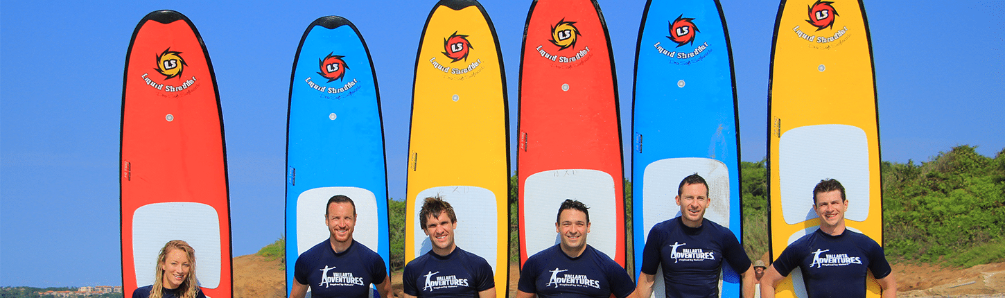 Six instructors with their paddle boards in Riviera Nayarit